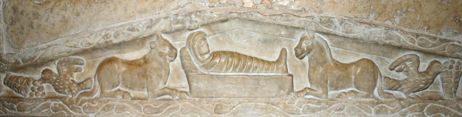 A carved relief of the Christ Child in a manger between an ox and an ass